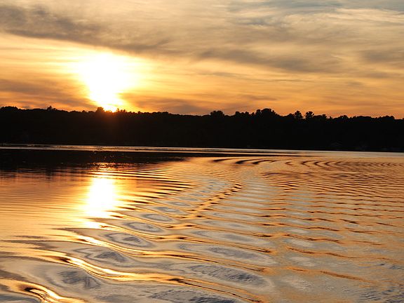 the lake at sunset boating