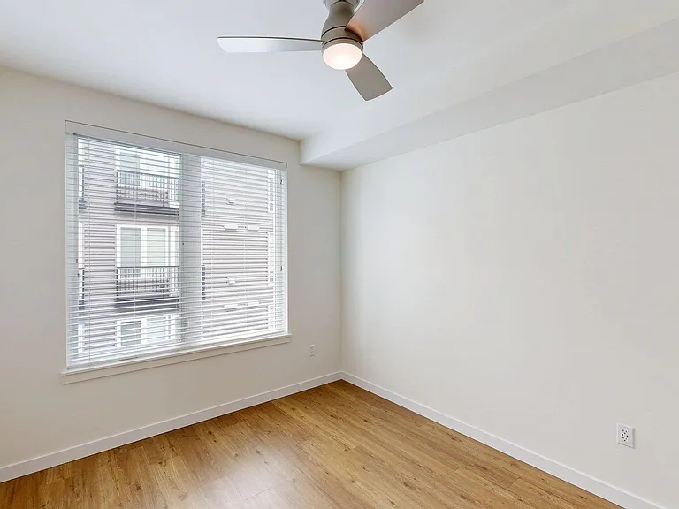Apartment bedroom with wood style floor.