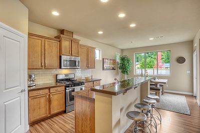 Contemporary, spacious kitchen with work island opens to dining area