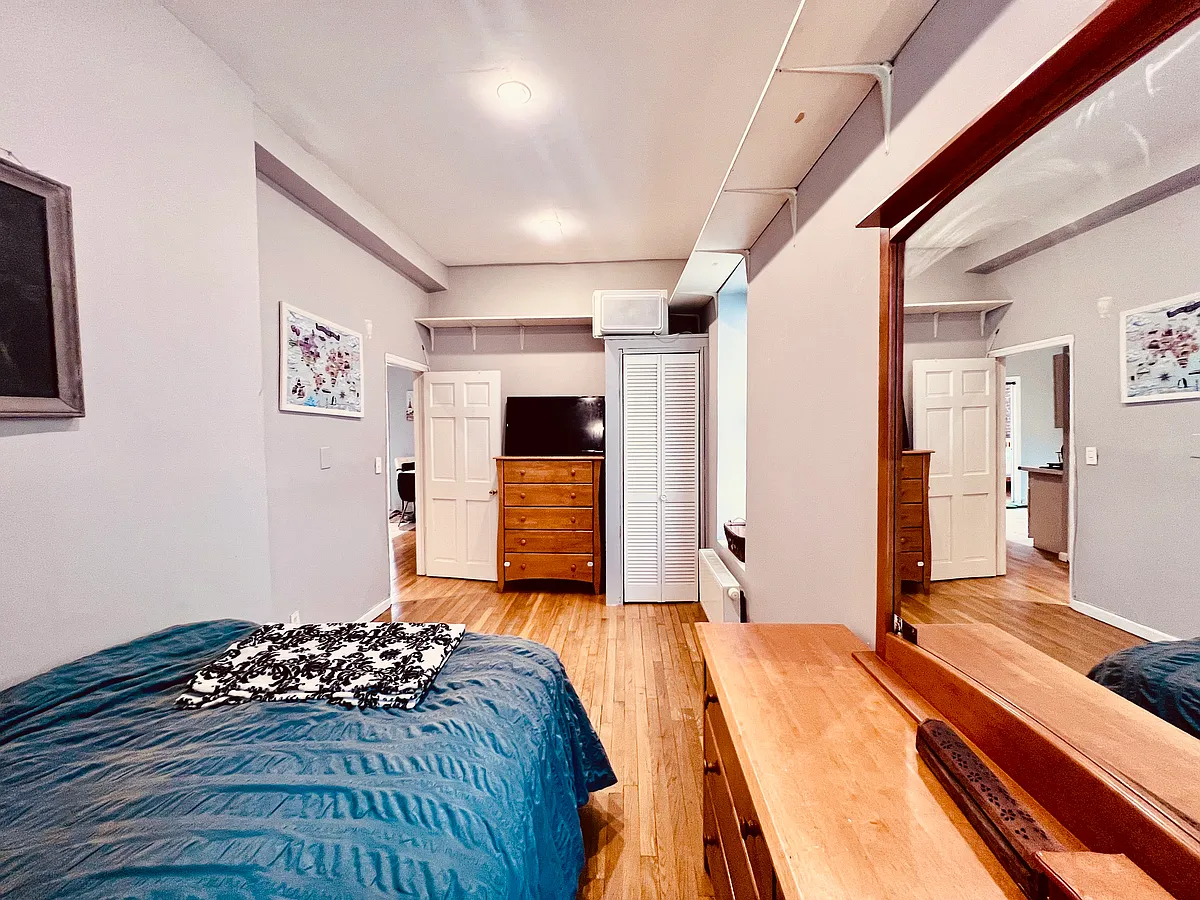 The bedroom (view 2)

The shelving above is convenient for additional storage in addition to the closet. - 274 E 7th St