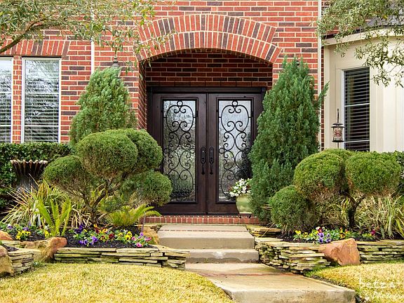 Lush landscaping surrounds front & back yard complete with irrigation system