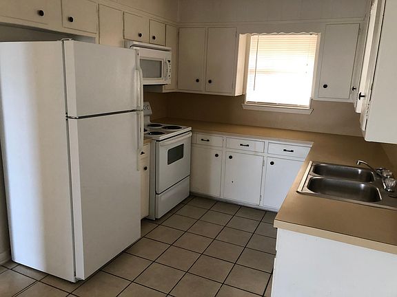 Kitchen with stove, refrigerator, dishwasher and microwave