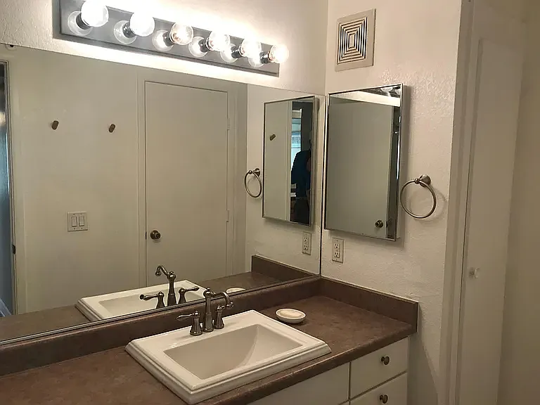 Jack and Jill Tube/Shower Bathroom with lockable door to 2nd bedroom and another lockable door to hallway for access from living room and kitchen