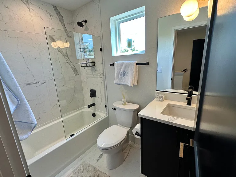Full Bathroom with natural light and modern glass shower door