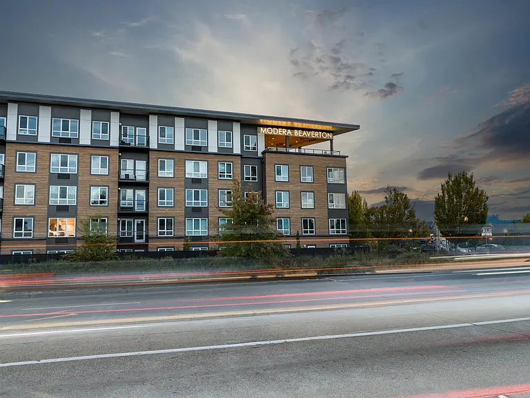 Evenings glow at Modera Beaverton, where contemporary architecture meets a prime location near dining, transit, and everyday essentials.