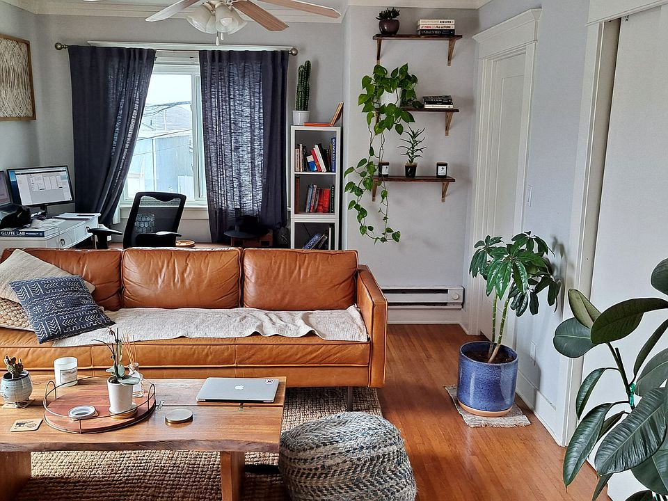 Spacious living room with double slider door to large private balcony.