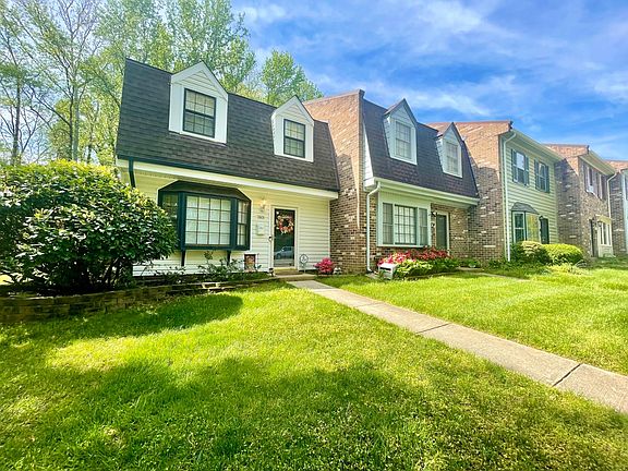 Lush, green lawn and shrubbery are professionally landscaped.