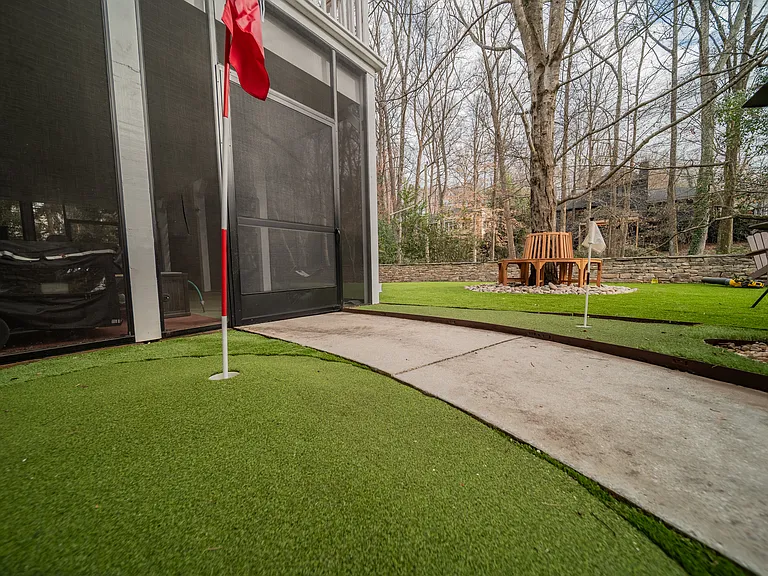 Golf holes in a turfed, no maintenance back yard. This photo shows some furnishings that have since been removed.