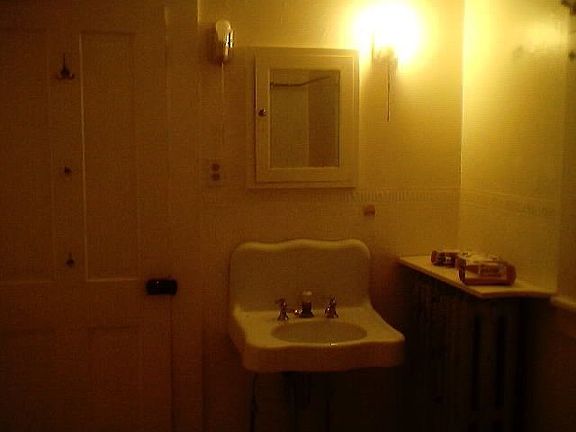 Huge upstairs bathroom sink heater medicine chest door to hall far side