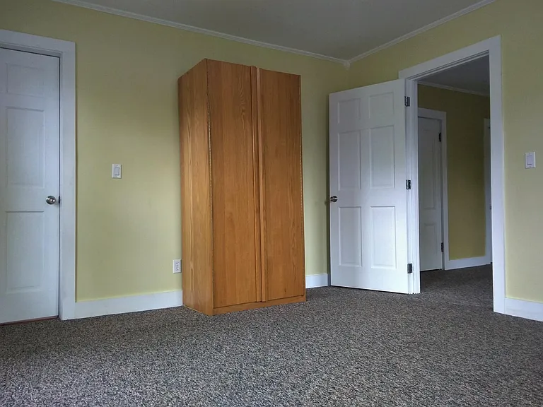 Wardrobe closet; entrance to living room on right.
