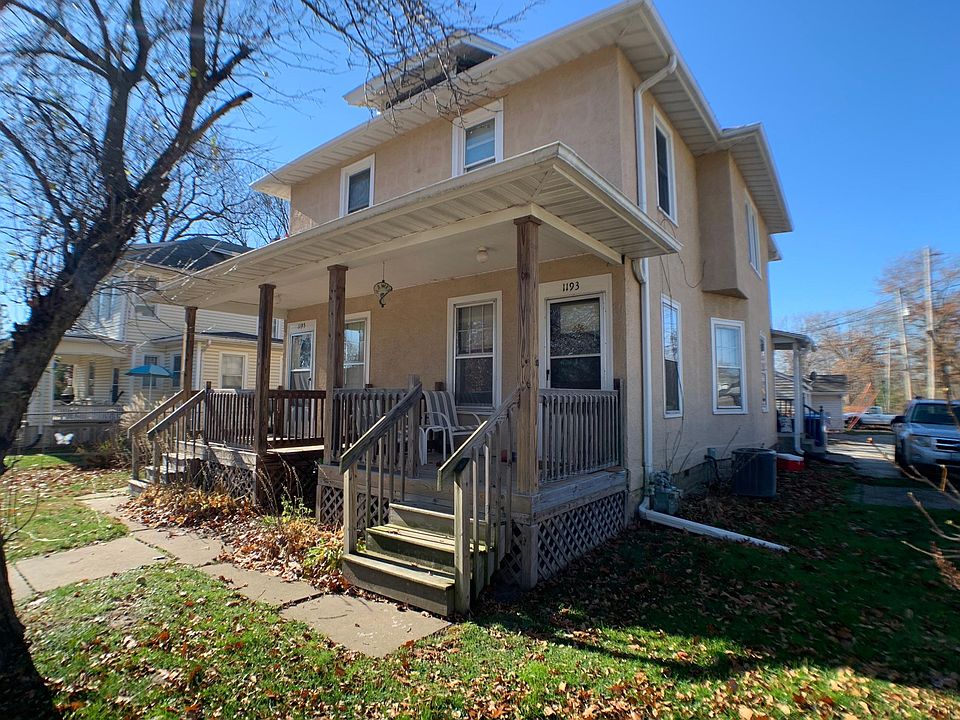 Front of townhouse Parking area and small brick patio to the right