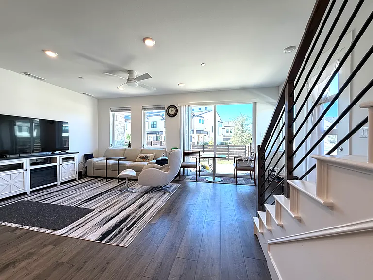 Large windows fill the home with natural light while showcasing neighborhood views.