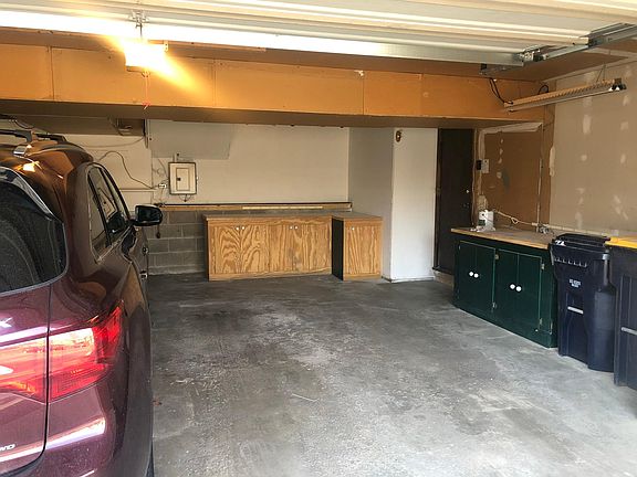 Two car Garage extra deep with cabinetry & shelving