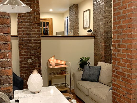 Soft Loft open floor plan with tall ceilings and exposed brick