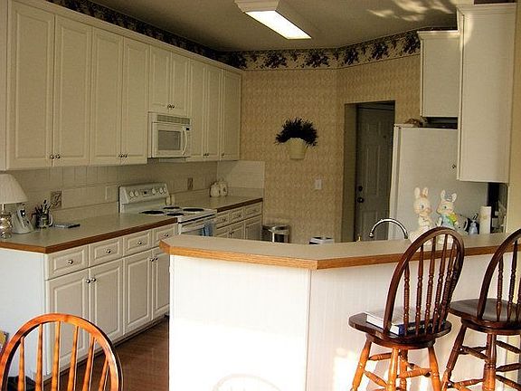 Tile backsplash, wood-accented counters, hardwoods