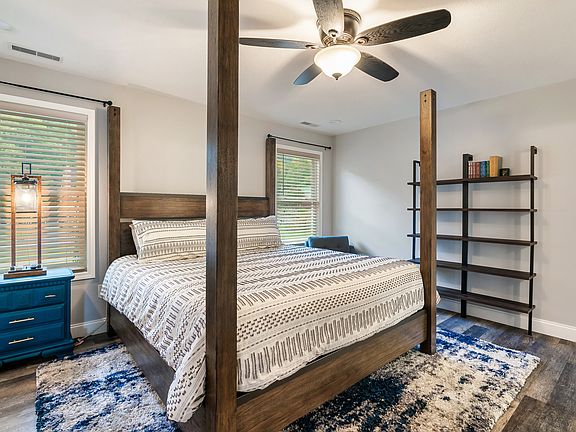 King poster bed in primary suite with Saatva mattress