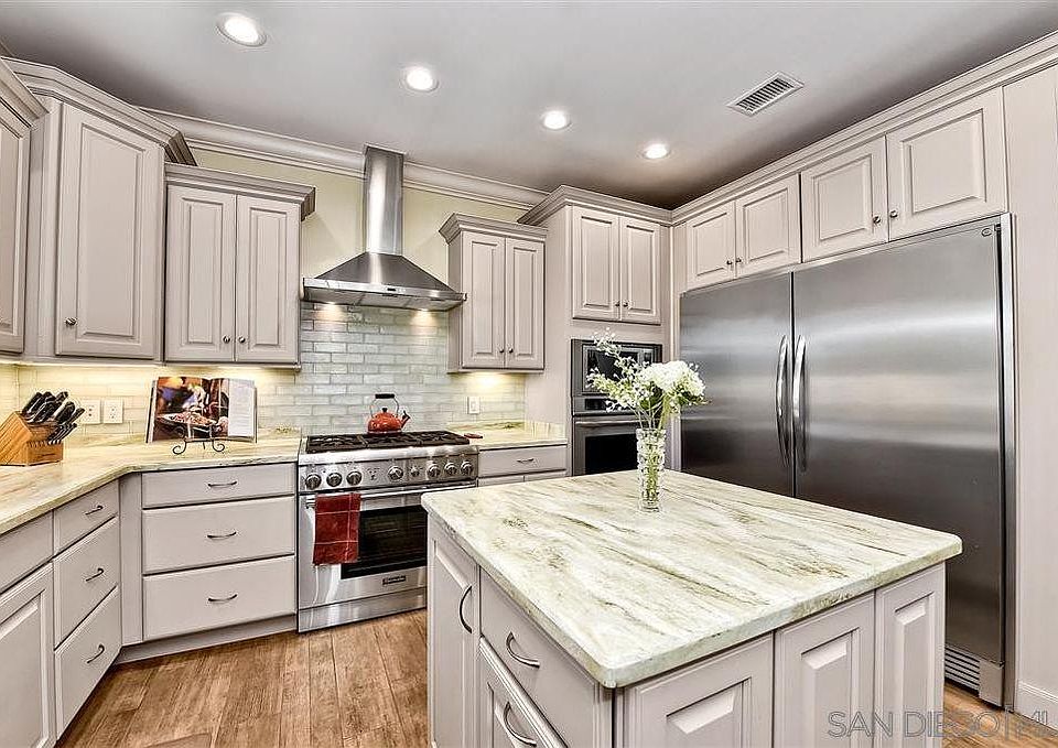 Large stainless steel side by side freezer and refrigerator and gas range with double oven for your cooking fun