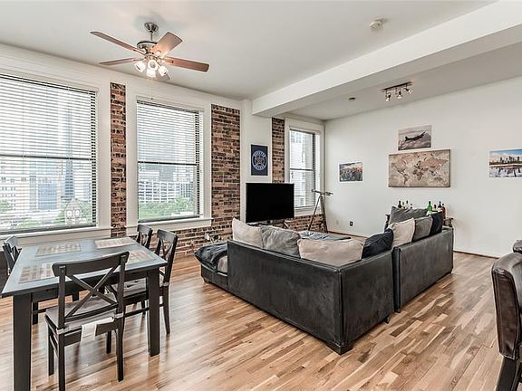 A closer look at the large space of the living area. Plenty of room to include a study/office or 2nd seating area as is done here. Spectacular views from the large windows which also provide tons of natural light!