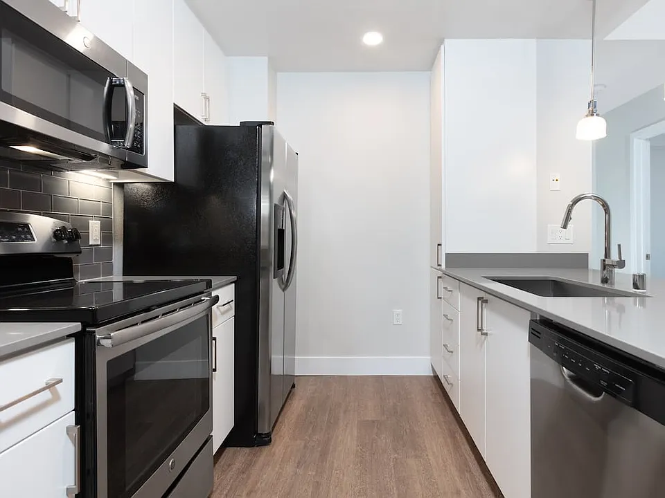 Renovated Phase I kitchen with stainless steel appliances and hard surface flooring
