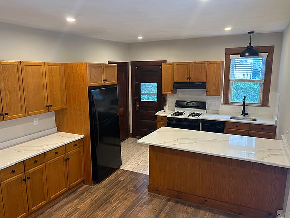 Huge eat-in kitchen with lots of cabinets, room for a table and breakfast bar