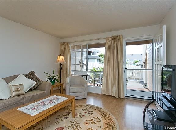 This spacious comfortable living area is bright and cheerful. A new screen door provides fresh air.