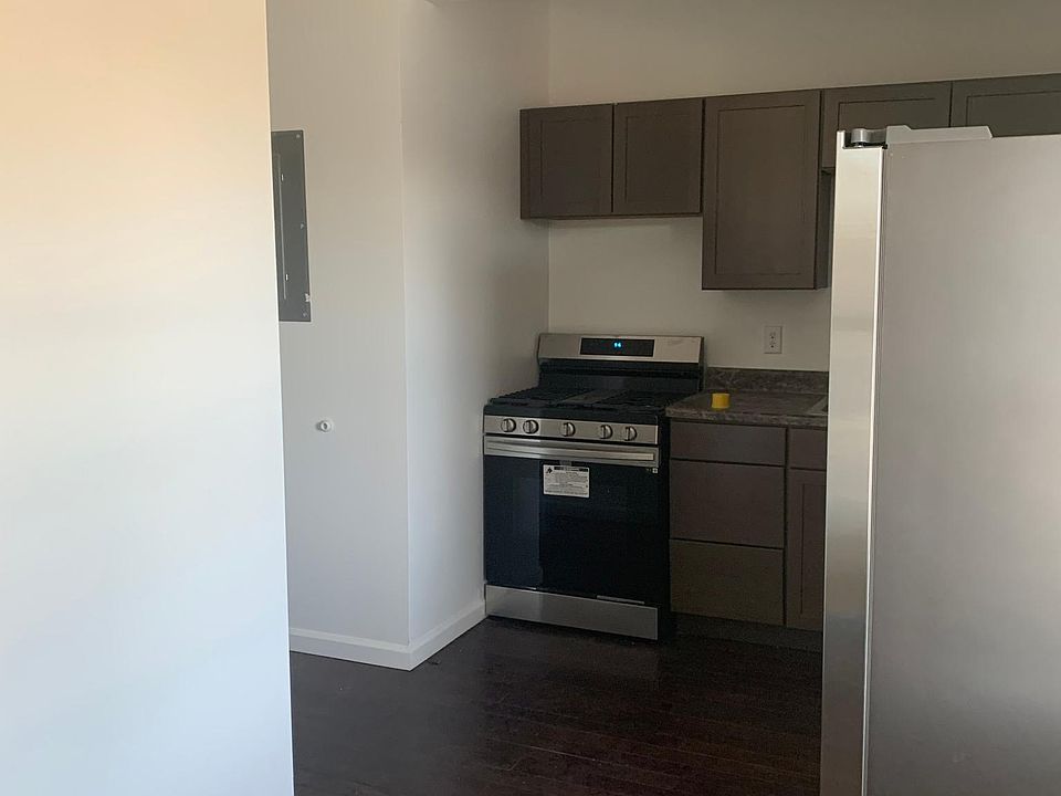 Kitchen with stainless steel appliances, hardwood floors and high ceilings! Lots of natural light!