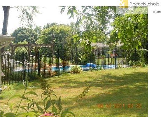 POOL ENCLOSED WITH ROD IRON FENCING