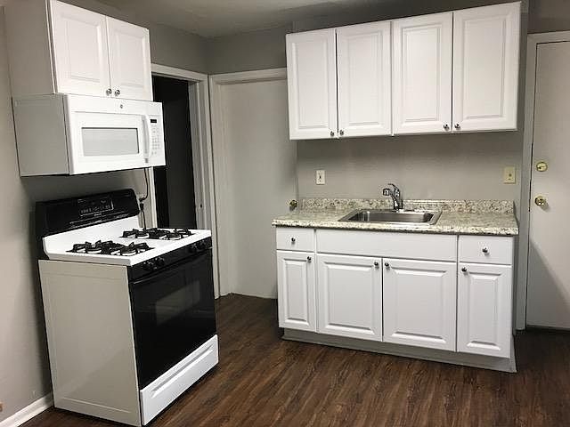 New sink, microwave, countertop, cabinets, floor and paint.