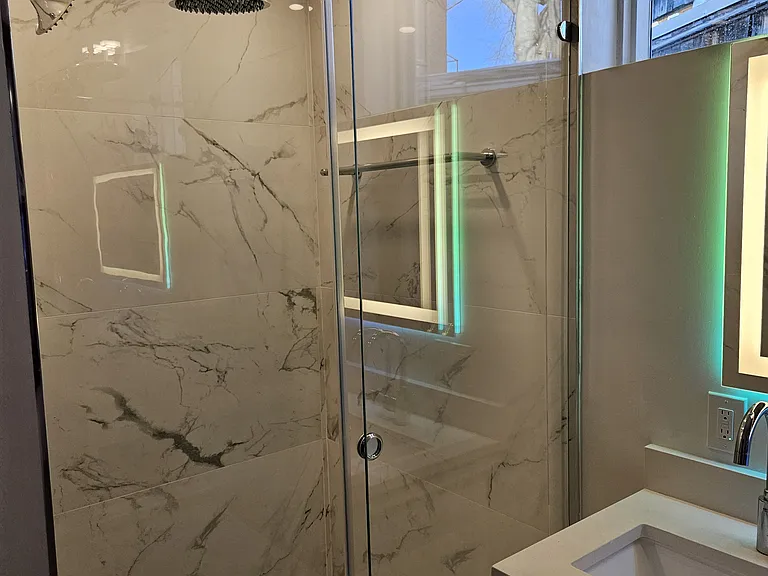 2nd floor suite: walk-in shower with with rain shower, head shower and hand shower, plus designer tiles.