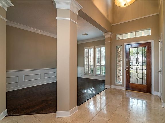 Formal dining is open to foyer and living area. Wood and stone flooring. Fresh interior paint thruout.