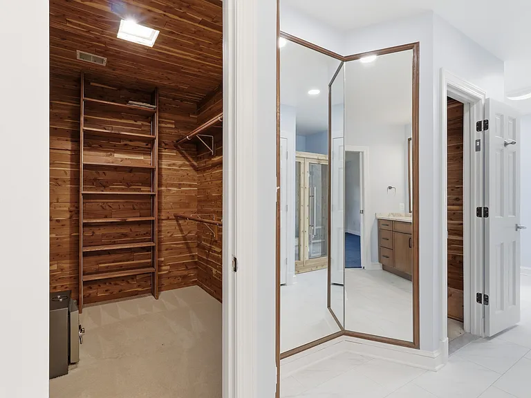 Two cedar-lined walk-in closets in primary suite.