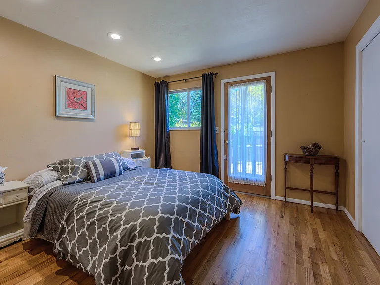 2nd bedroom has a queen bed with back yard access.
