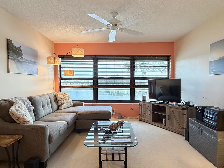 Cozy up and enjoy SPECTACULAR lake & golf course views from the living room!