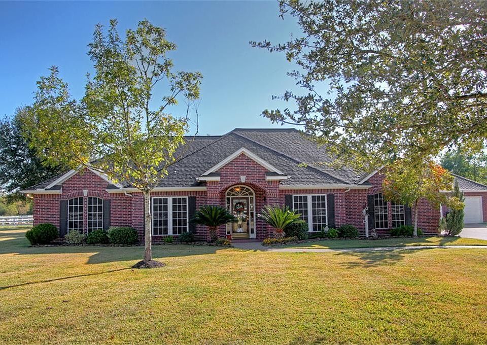 All brick 1-story home with mature and young oak trees all around. 