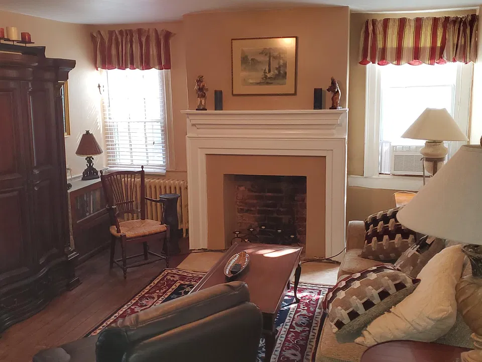 Living room with fireplace and ac unit