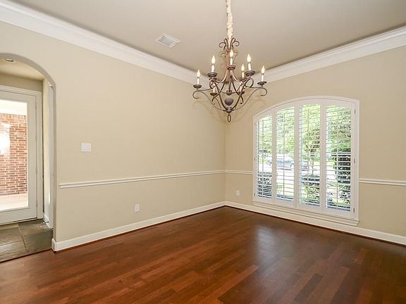 Formal dining room with newly refinished hardwood floors.