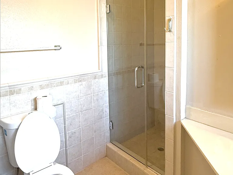 Master bathroom: remodeled with tile and stone. Walk in shower, new toilet and tile floors.