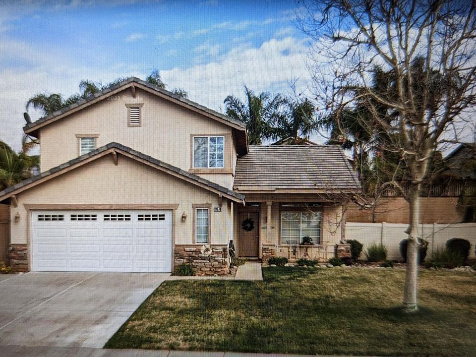Front of house, 2 car garage with additional parking for third vehicle