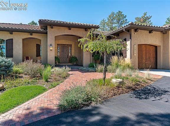 Announce your arrival at this beautiful home in a woodland setting