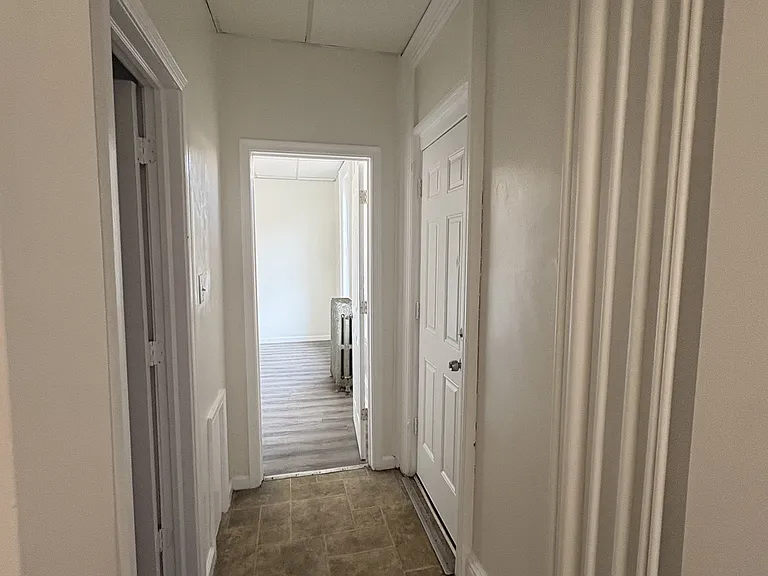 Hallway to bathroom, bedroom and side entrance