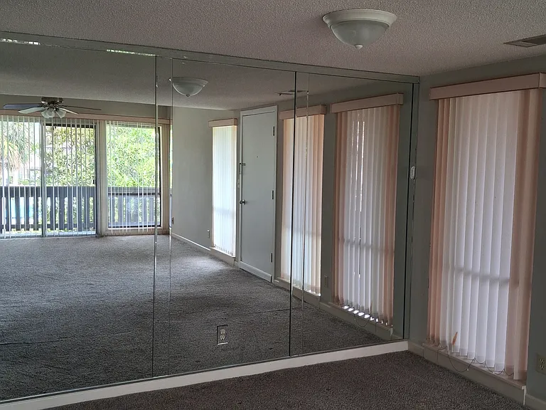 Dining area near kitchen with mirrored wall and open to Living Room.