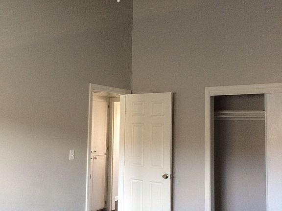 Bedroom with large closet and ceiling fan