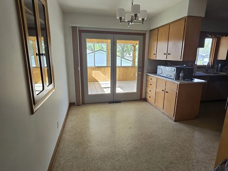 dining room main floor connected to kitchen and 3 seasons porch