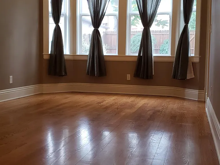 Mater bedroom suite with large bay windows and accent lighting.