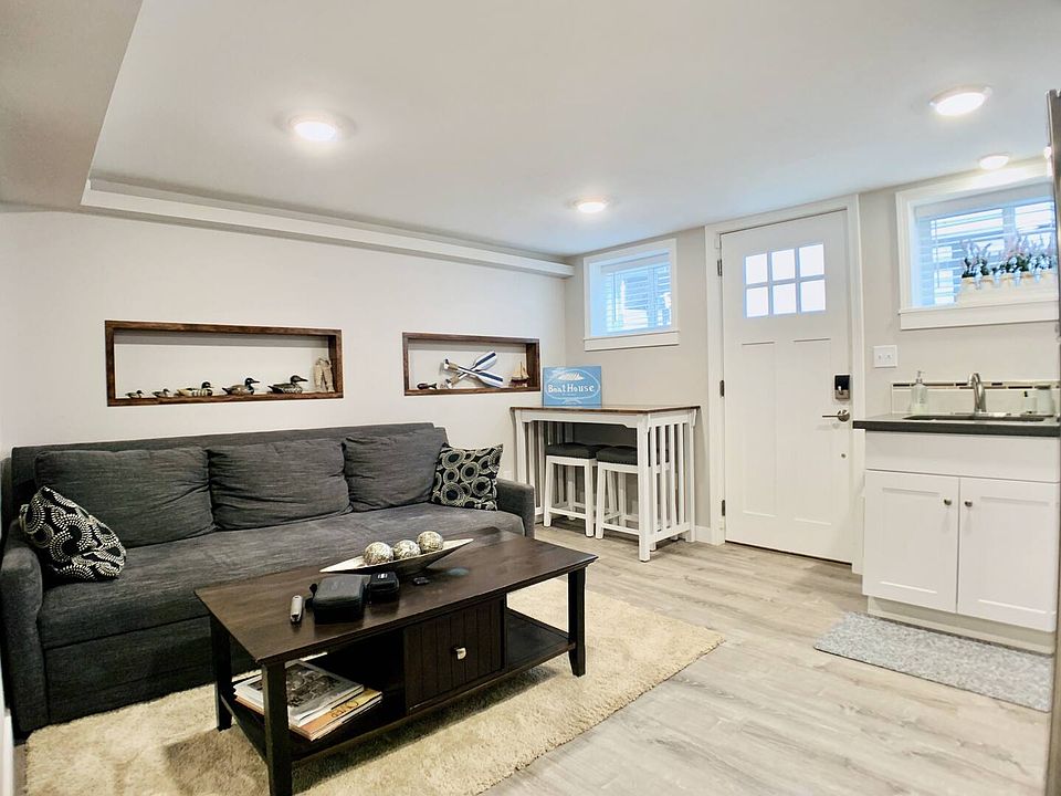 Livingroom, entrance door, and kitchen sink area.