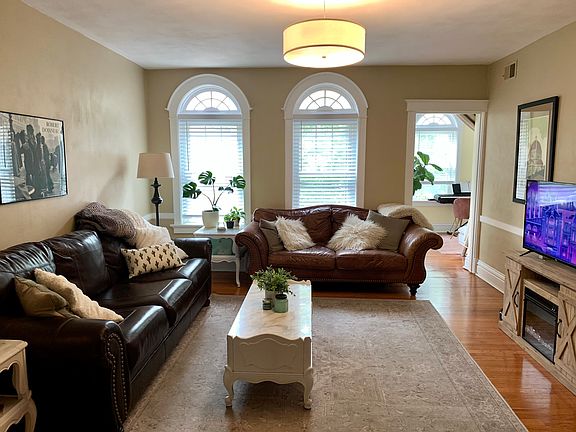 Sunny, south facing living room, with direct access to the sunroom, currently used as an office.