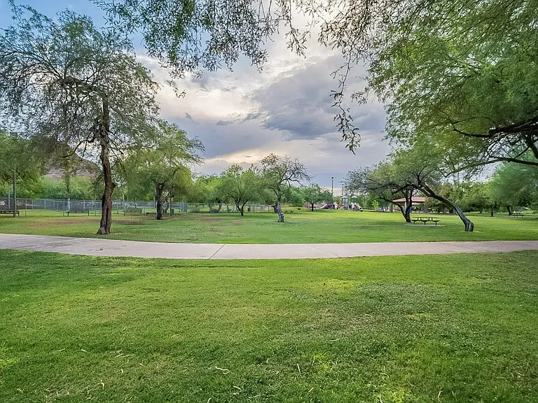 Walking paths through trees, grass, and by the lake
