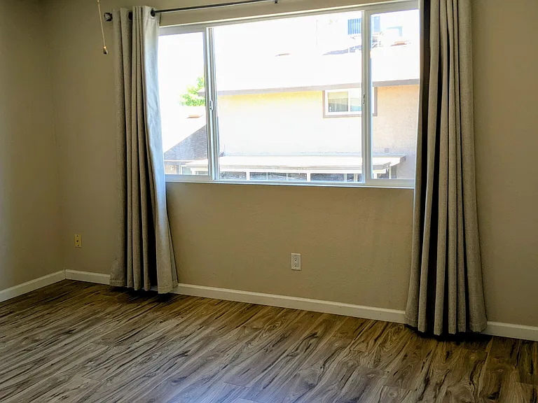 Primary bedroom with light blocking drapes
