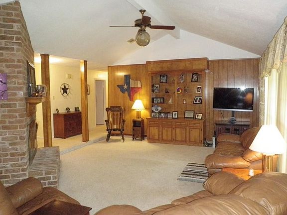 Spacious family room with built-ins & vaulted ceiling.