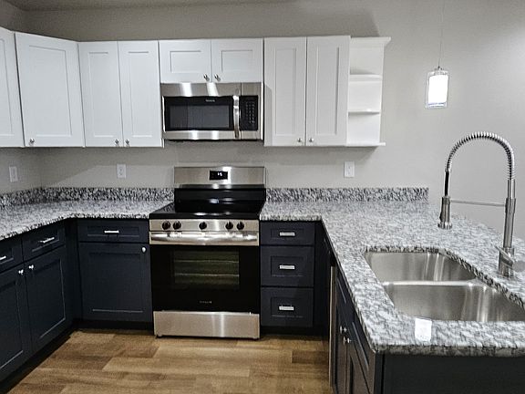 Modern appliances with generous cabinet and countertop space